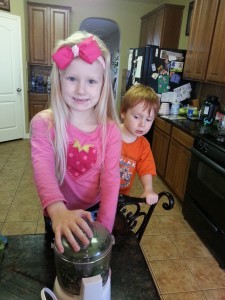 Rylee and Henry making pesto