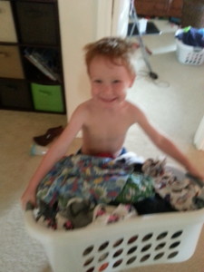Little Man.  Big basket of laundry.  Cause he changes outfits 9 times a day.