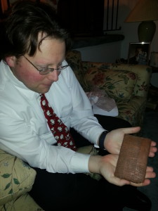 Holding an artifact from his history class
