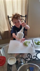 My son helping to cut up vegetables